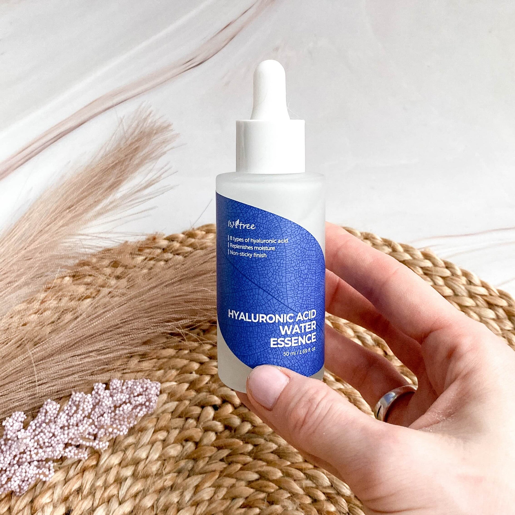 Persoon houdt de Isntree Hyaluronic Acid Water Essence vast